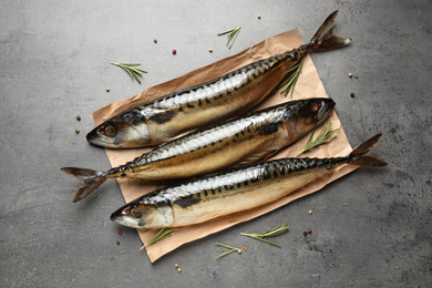 Photo of Tasty smoked fish on grey table, flat lay