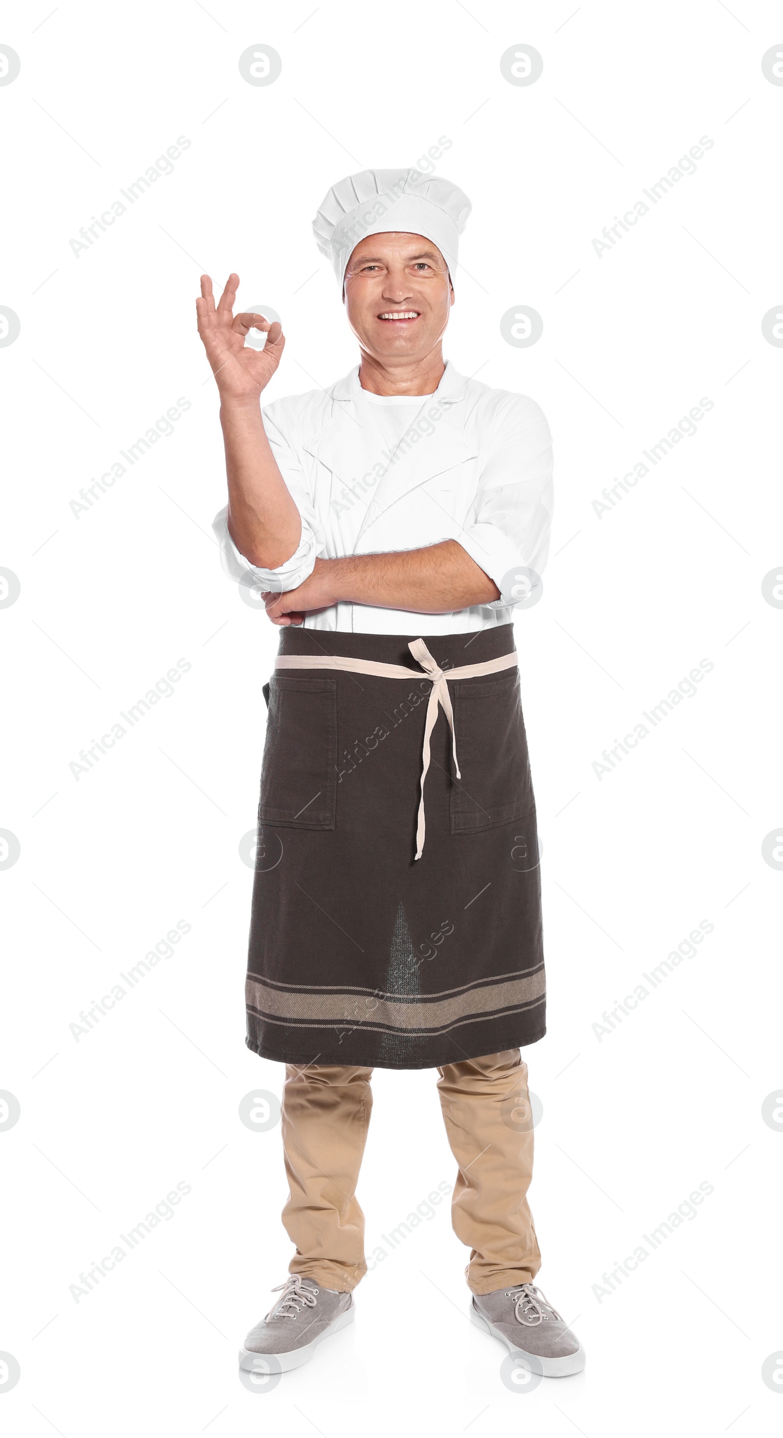 Photo of Mature male chef showing perfect sign on white background