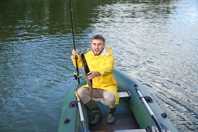 Photo of Man with rod fishing from boat. Recreational activity