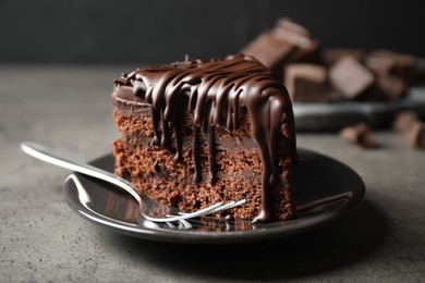 Tasty chocolate cake served on grey table