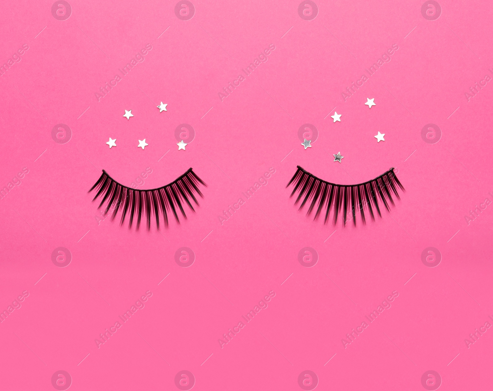 Photo of False eyelashes and sparkles on pink background, flat lay