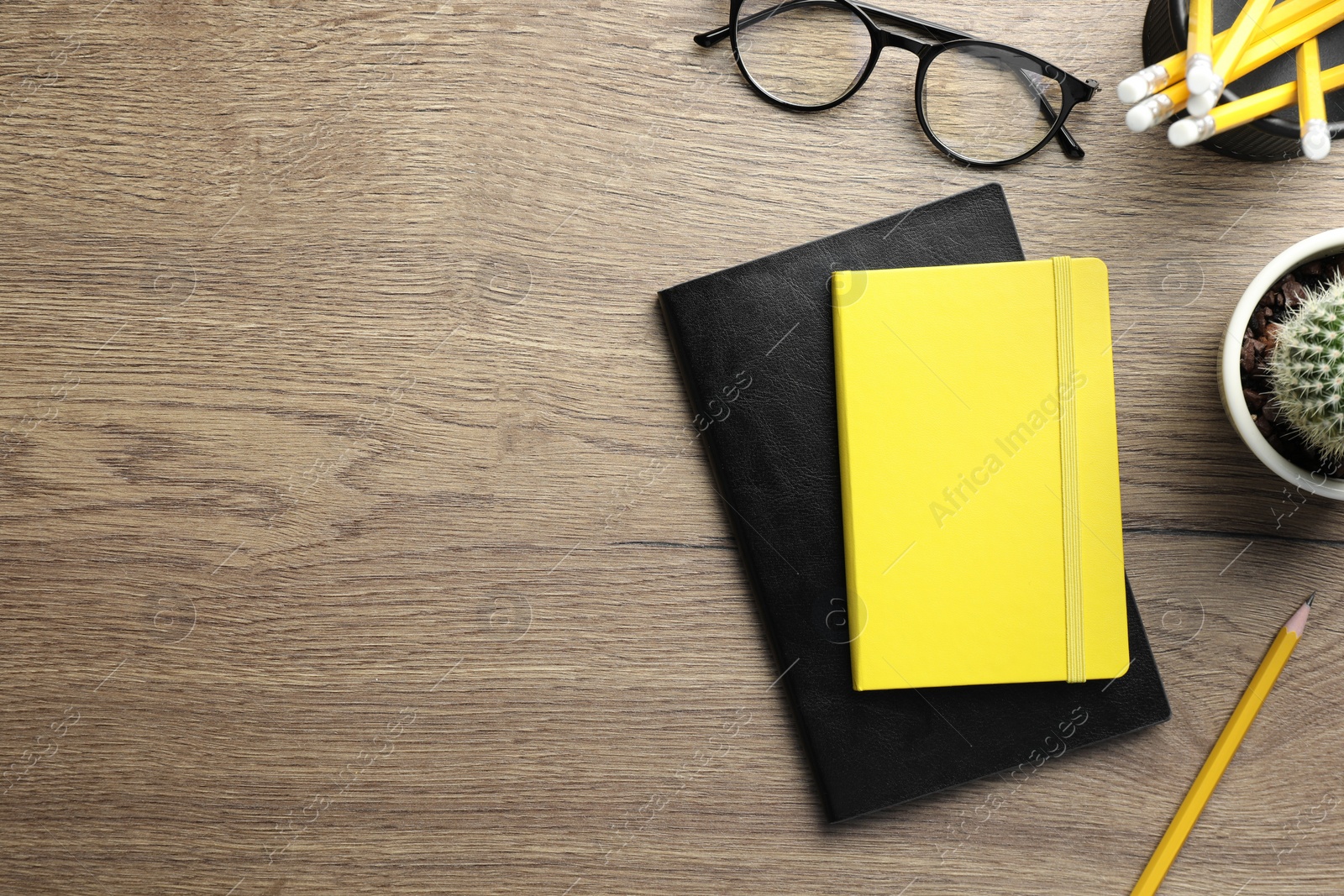 Photo of Flat lay composition with notebooks on wooden table. Space for text