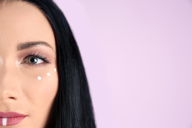 Photo of Young hippie woman with boho makeup on color background, closeup