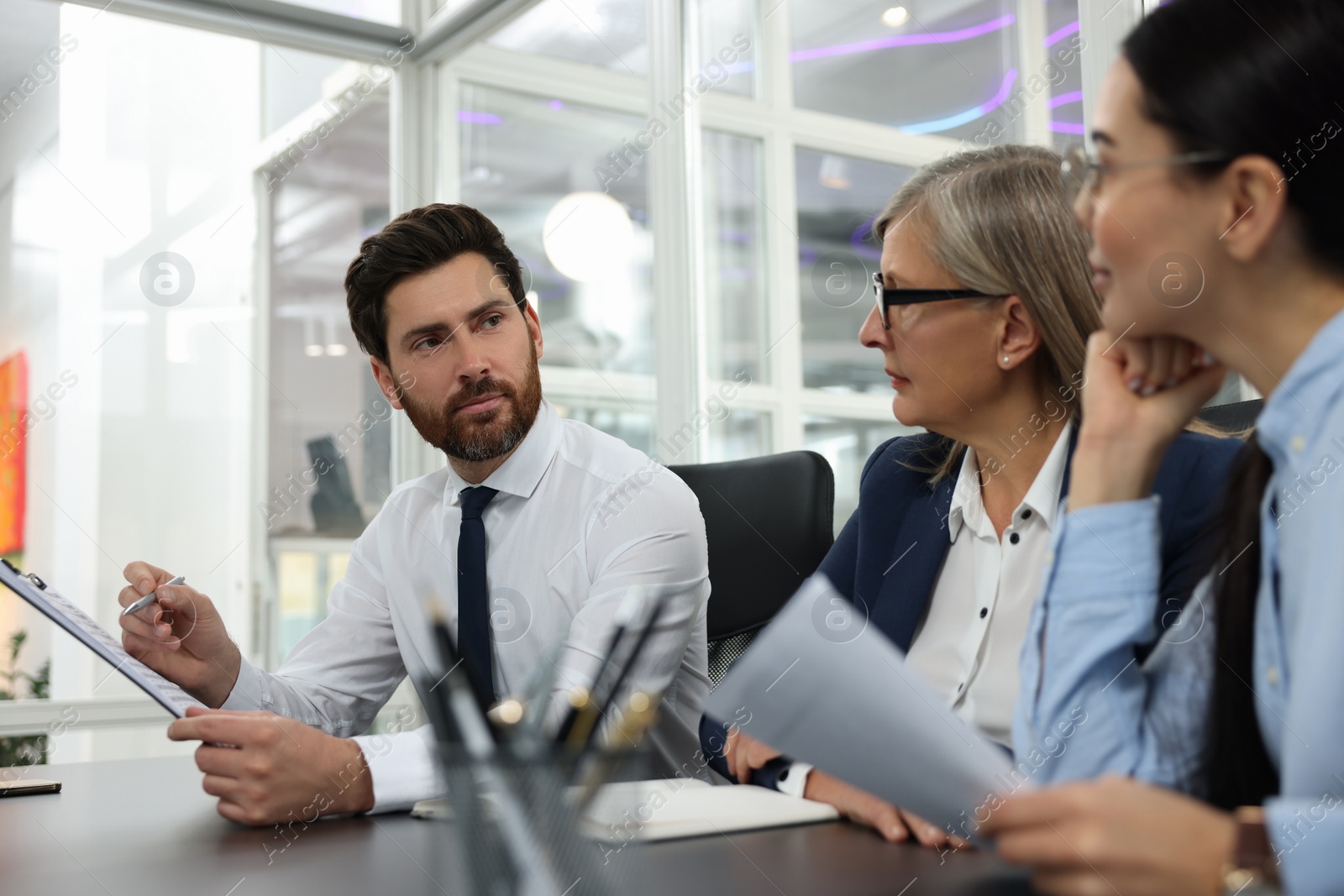 Photo of Lawyers working together at table in office