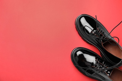 Pair of stylish female shoes on red background, flat lay. Space for text