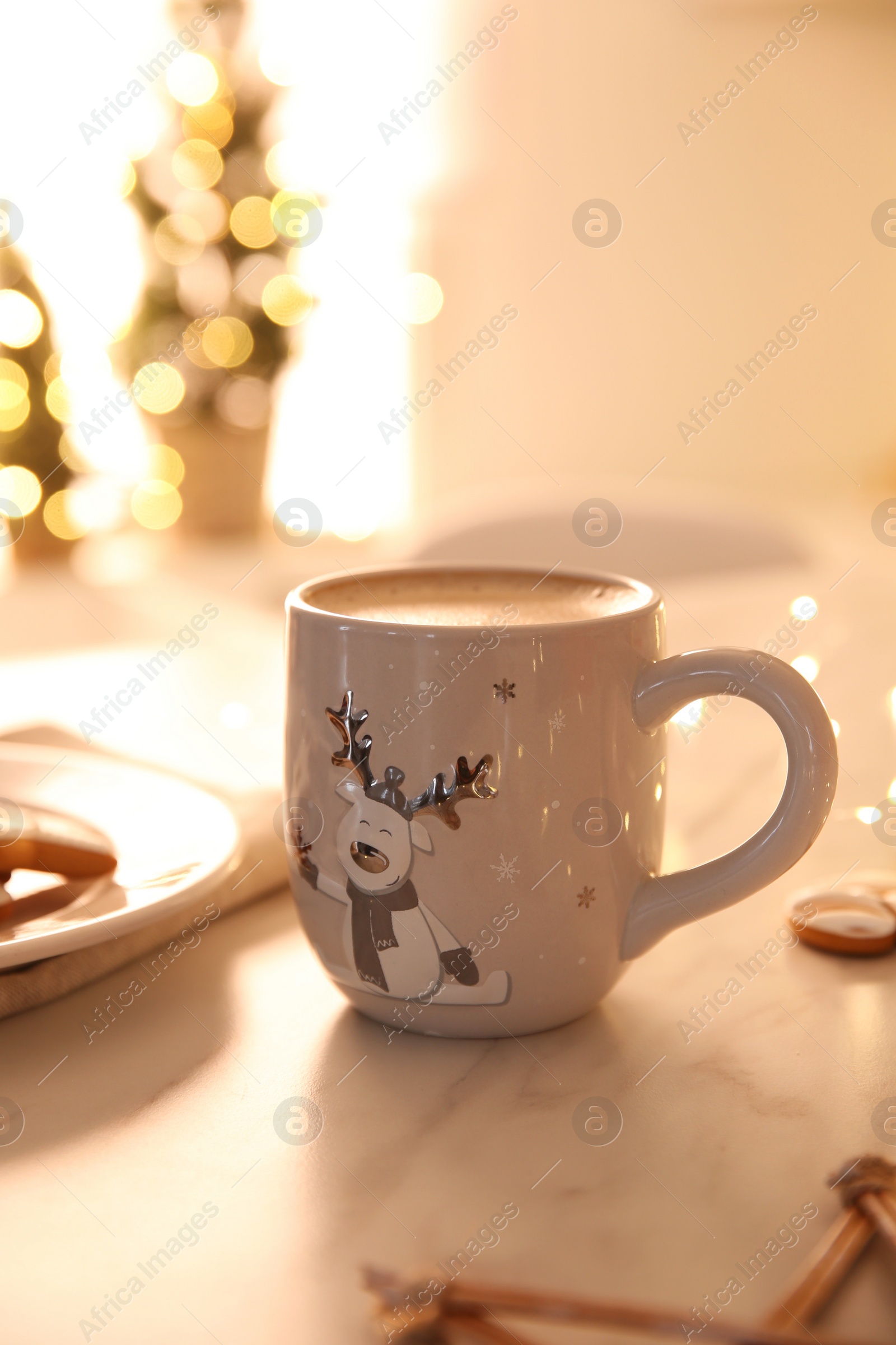 Photo of Cup with hot drink on light table indoors