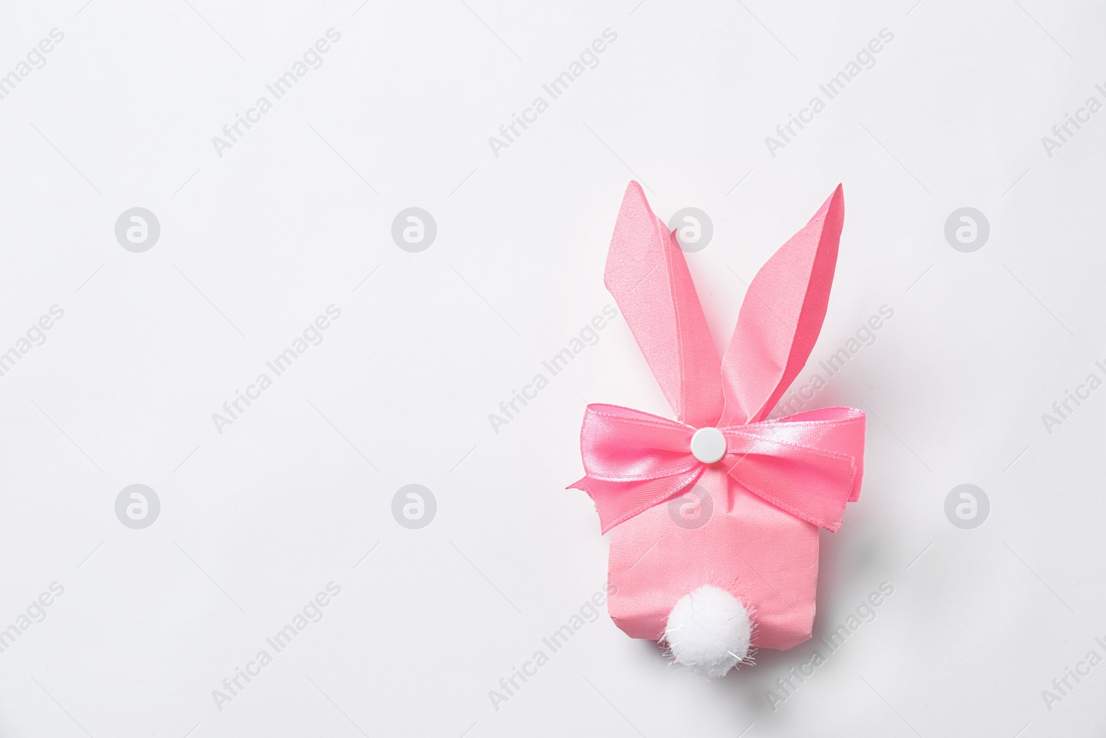 Photo of Creative Easter bunny gift bag on white background, top view