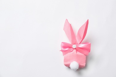 Photo of Creative Easter bunny gift bag on white background, top view