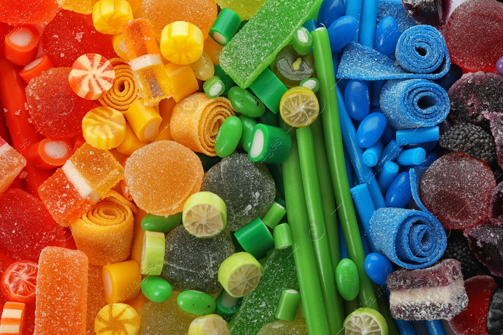 Photo of Pile of delicious colorful chewing candies as background