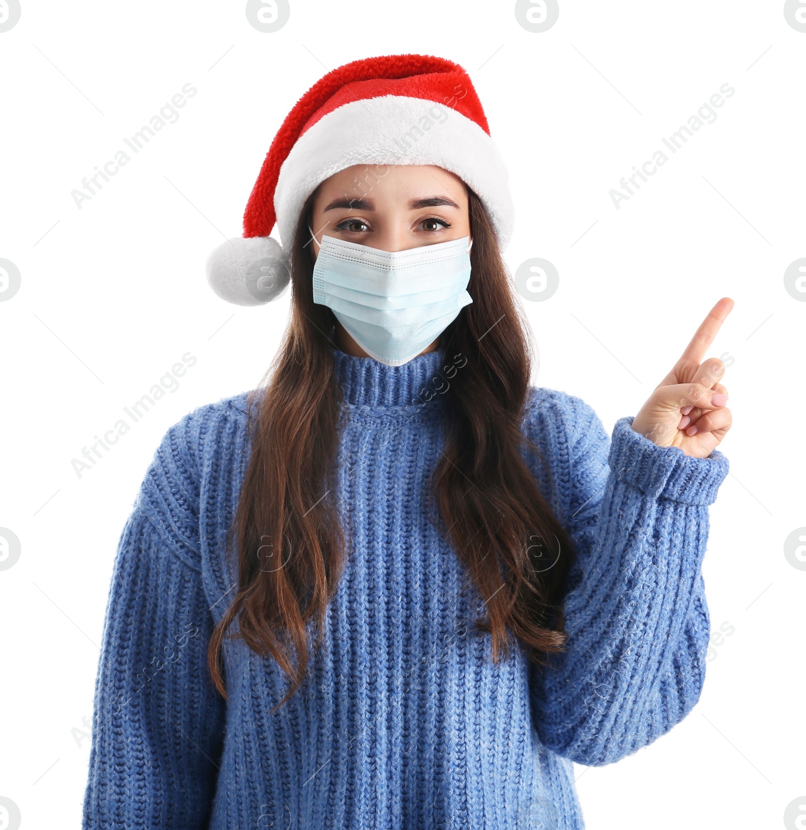 Photo of Beautiful woman wearing Santa Claus hat and medical mask on white background