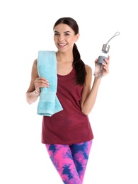 Beautiful young woman in sportswear with towel and bottle of water on white background