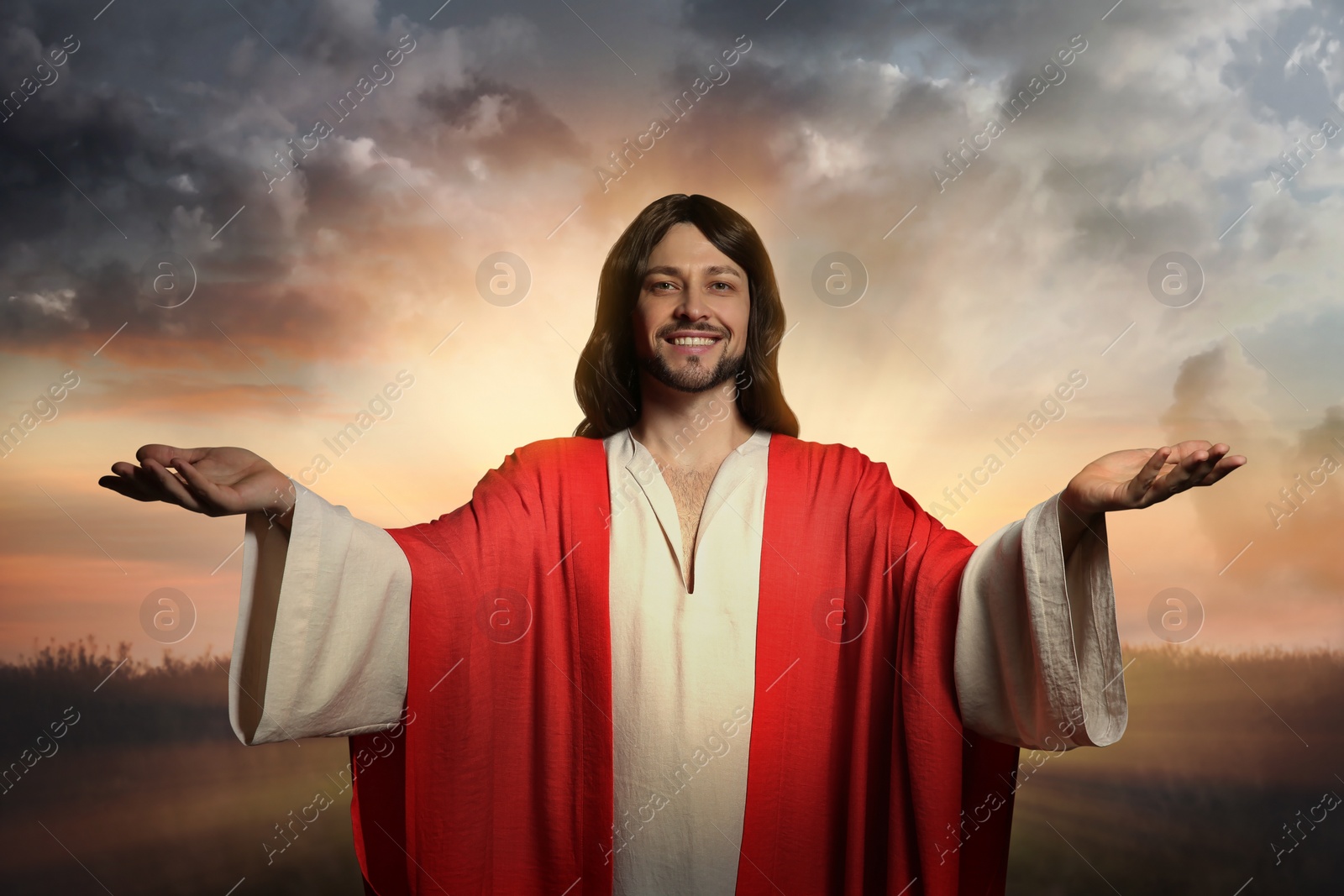 Image of Jesus Christ with outstretched arms outdoors 