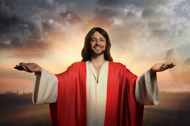Image of Jesus Christ with outstretched arms outdoors 