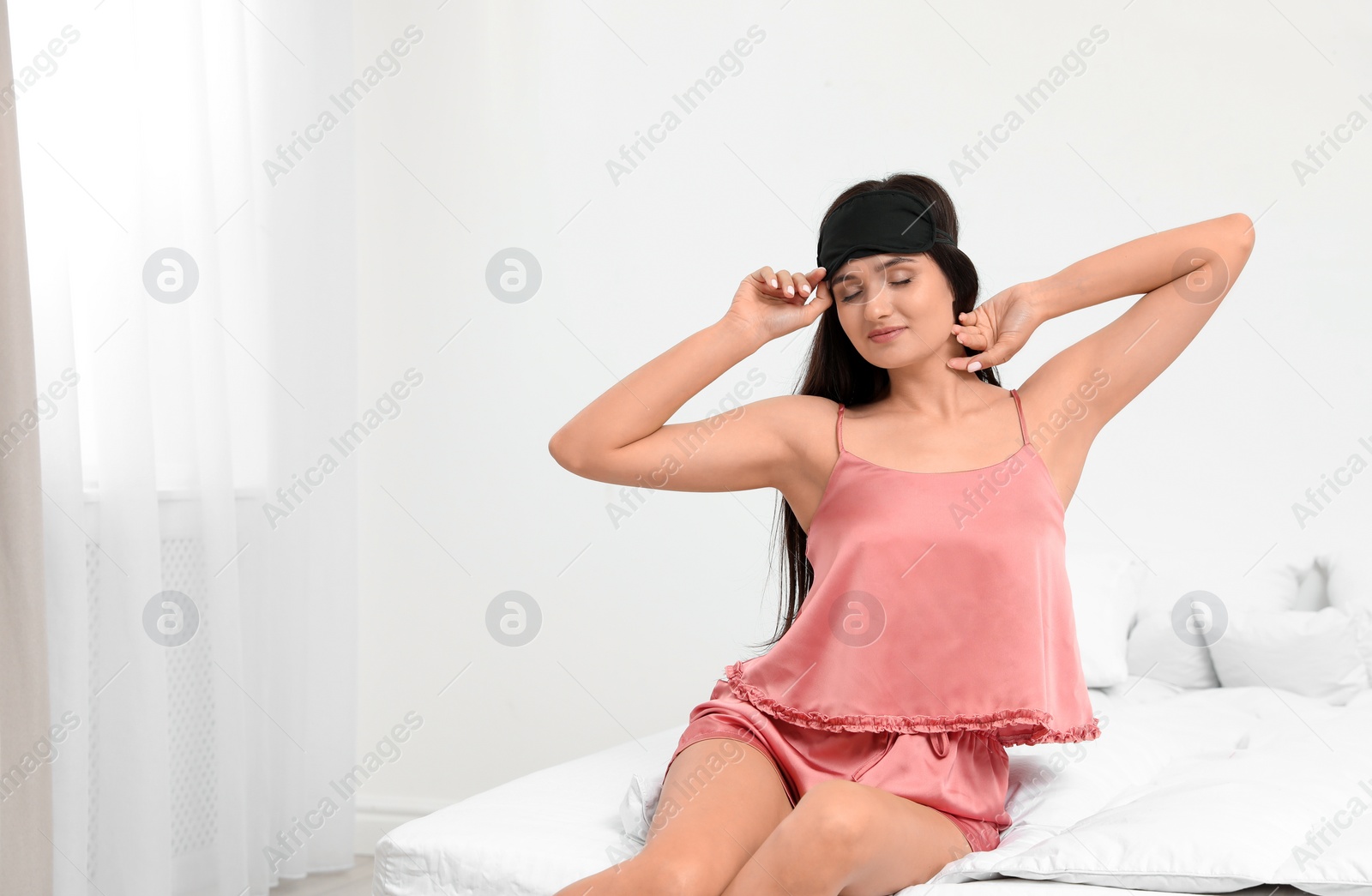 Photo of Beautiful woman wearing sleeping mask at home. Bedtime