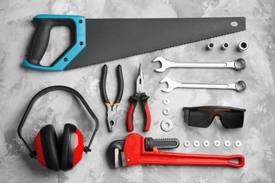 Photo of Flat lay composition with different construction tools on grey background