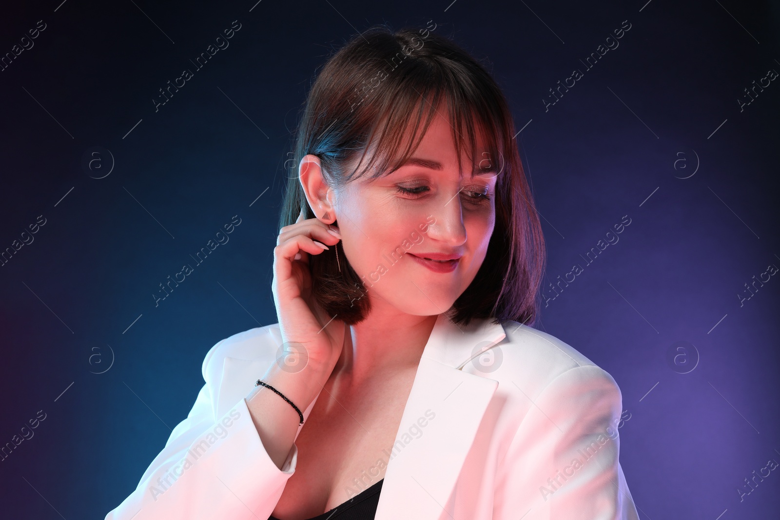 Photo of Portrait of happy woman on dark background