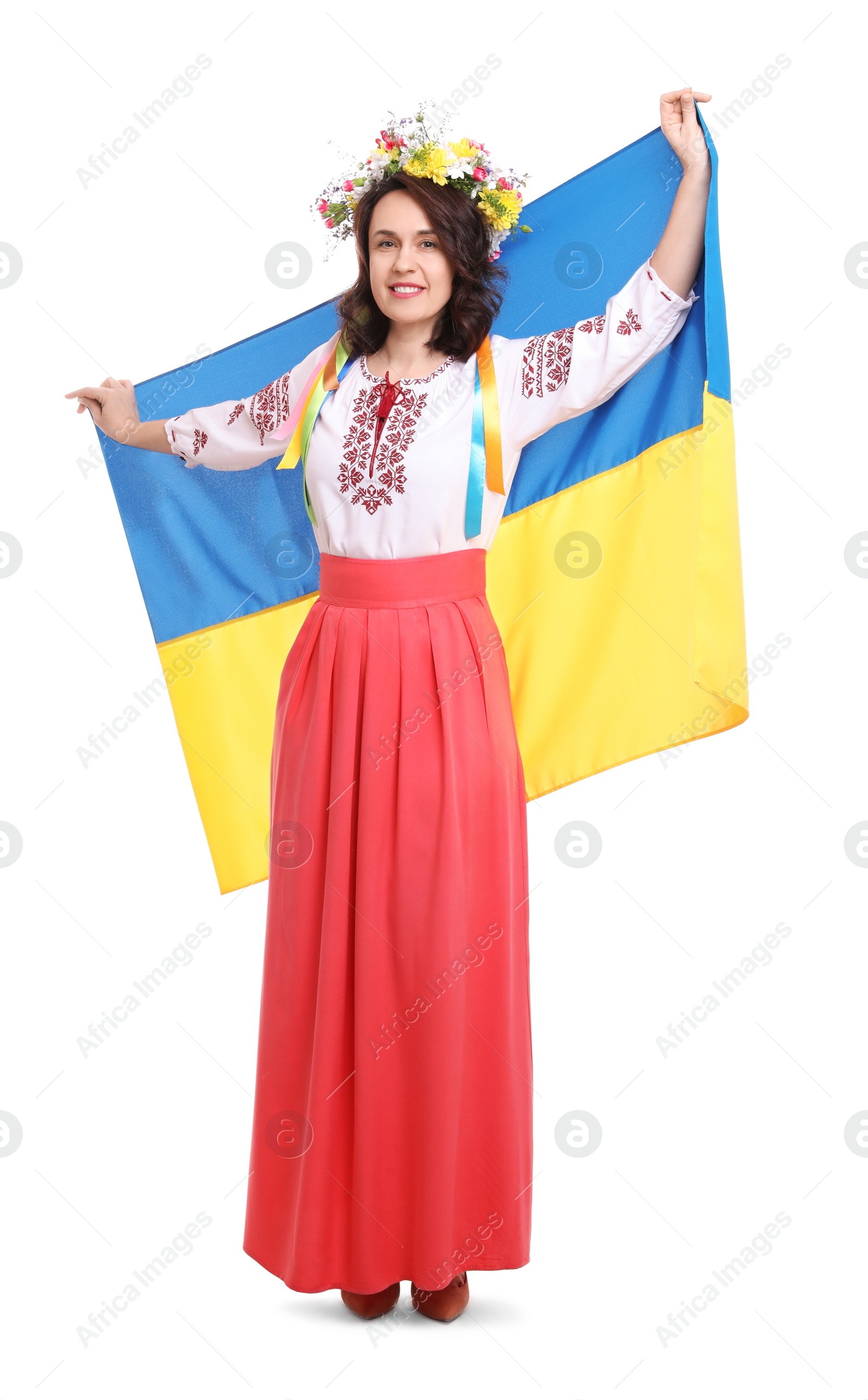 Photo of Happy woman in national clothes with flag of Ukraine on white background