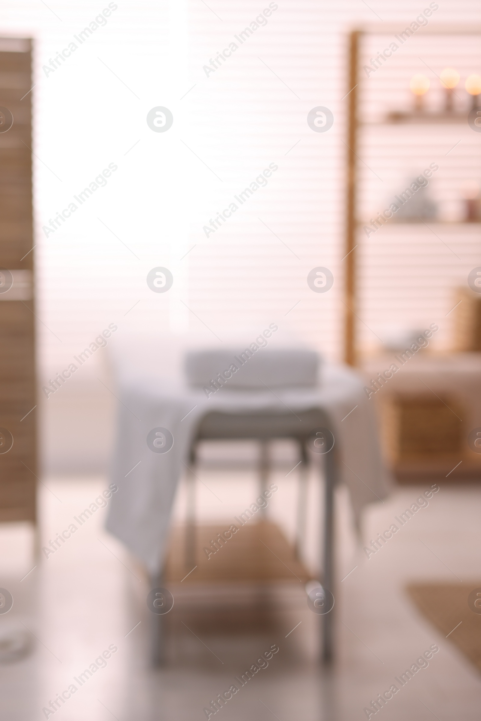 Photo of Cozy massage room with equipment, blurred view