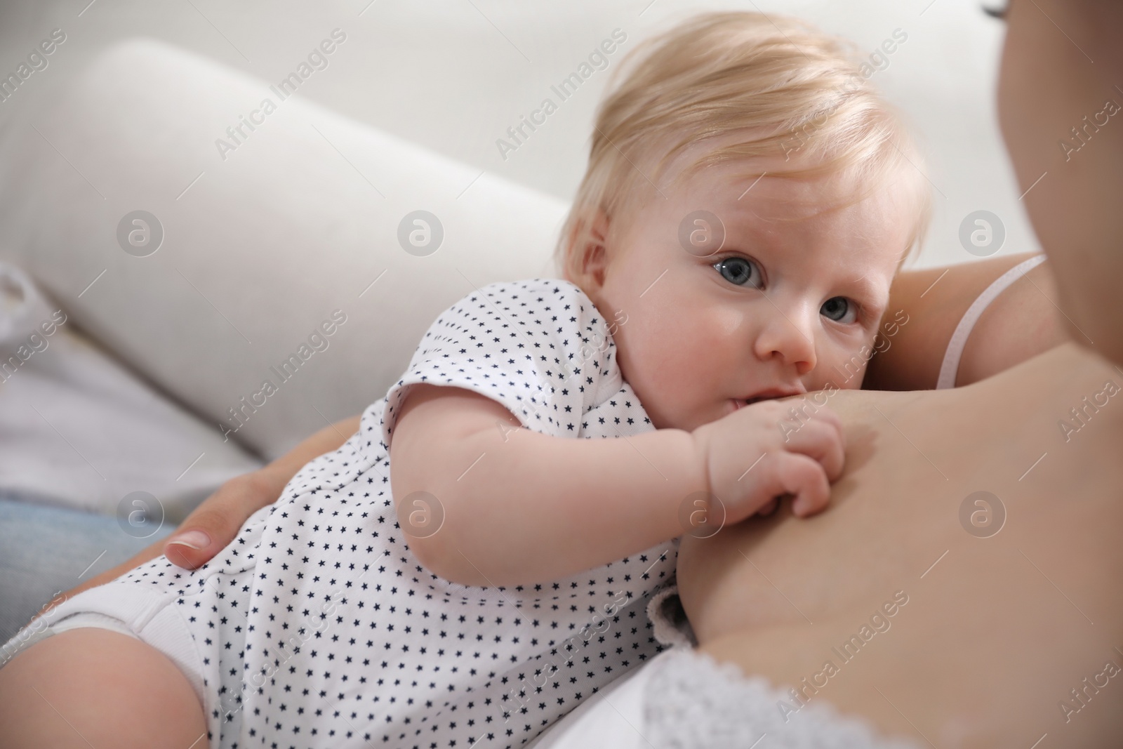 Photo of Mother breastfeeding her cute little baby, closeup