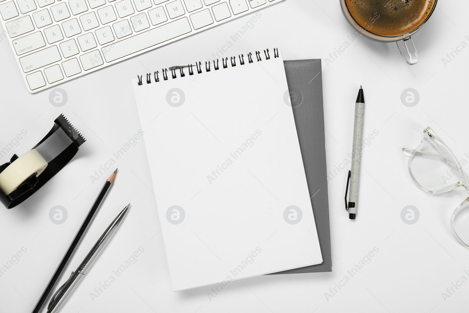 Photo of Flat lay composition with notebooks and coffee on white table