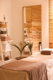 Photo of Stylish massage room interior in spa salon