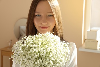 Happy bride with beautiful bouquet indoors. Wedding day