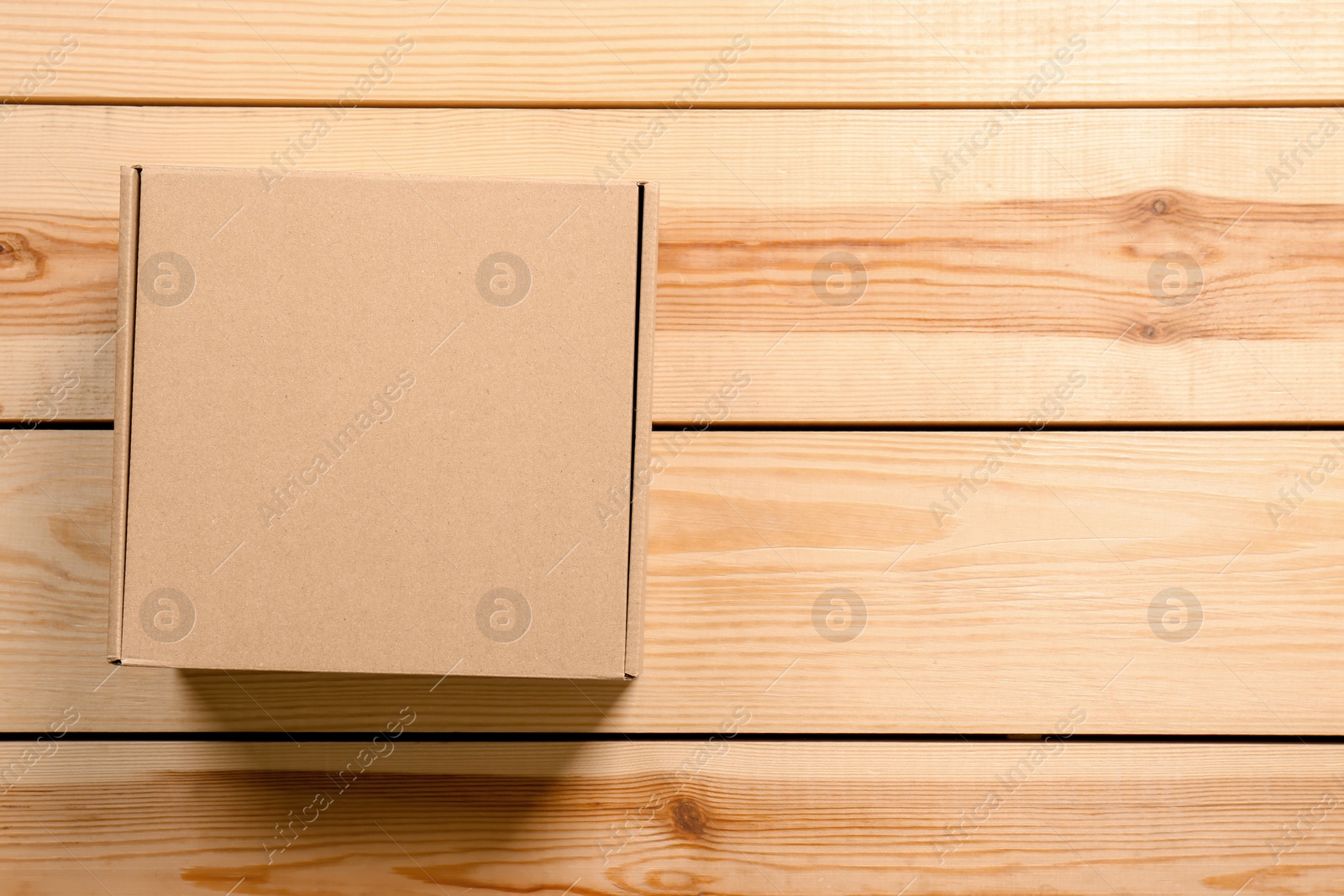 Photo of Cardboard box on wooden background