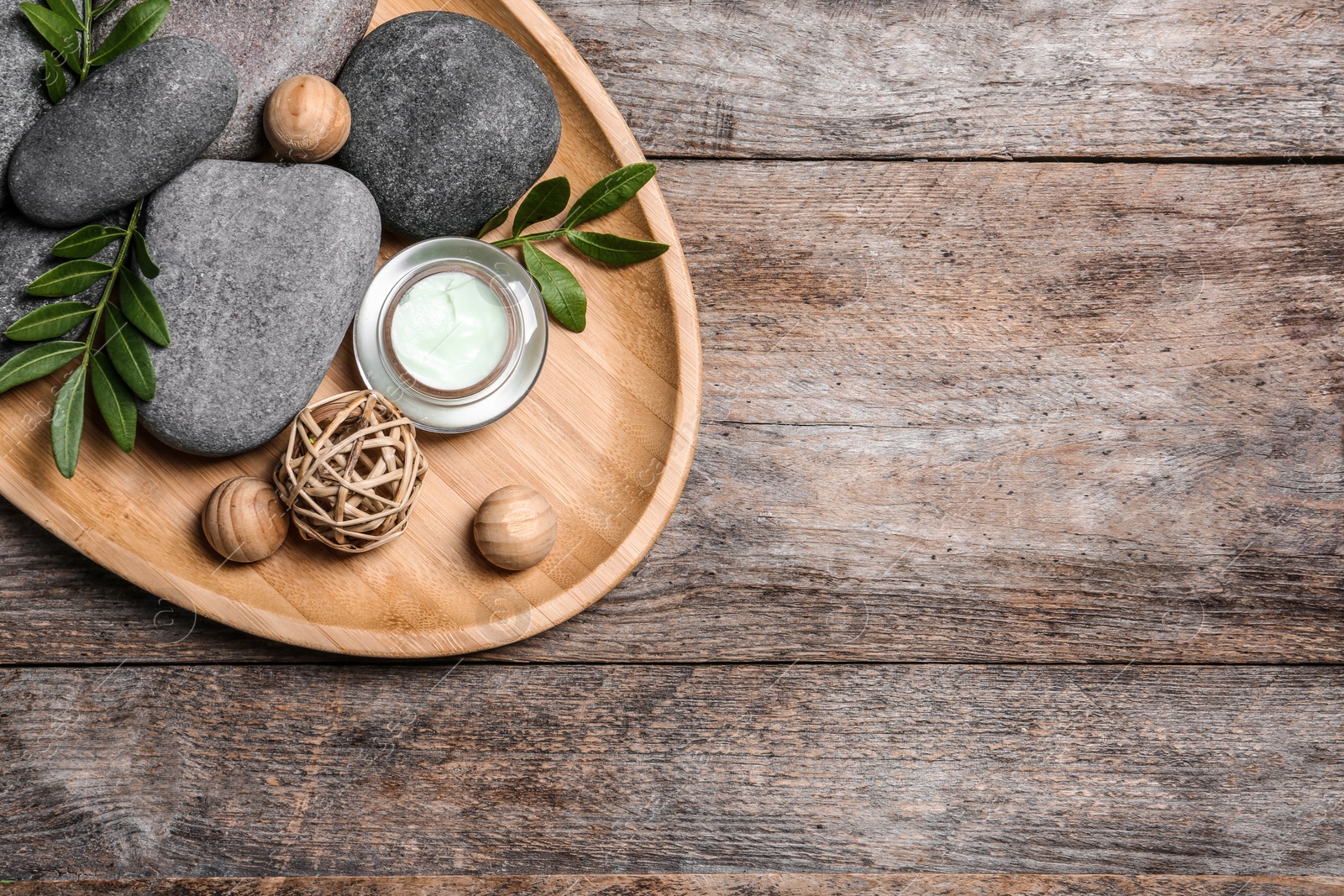 Photo of Composition with spa stones on wooden background, top view. Space for text