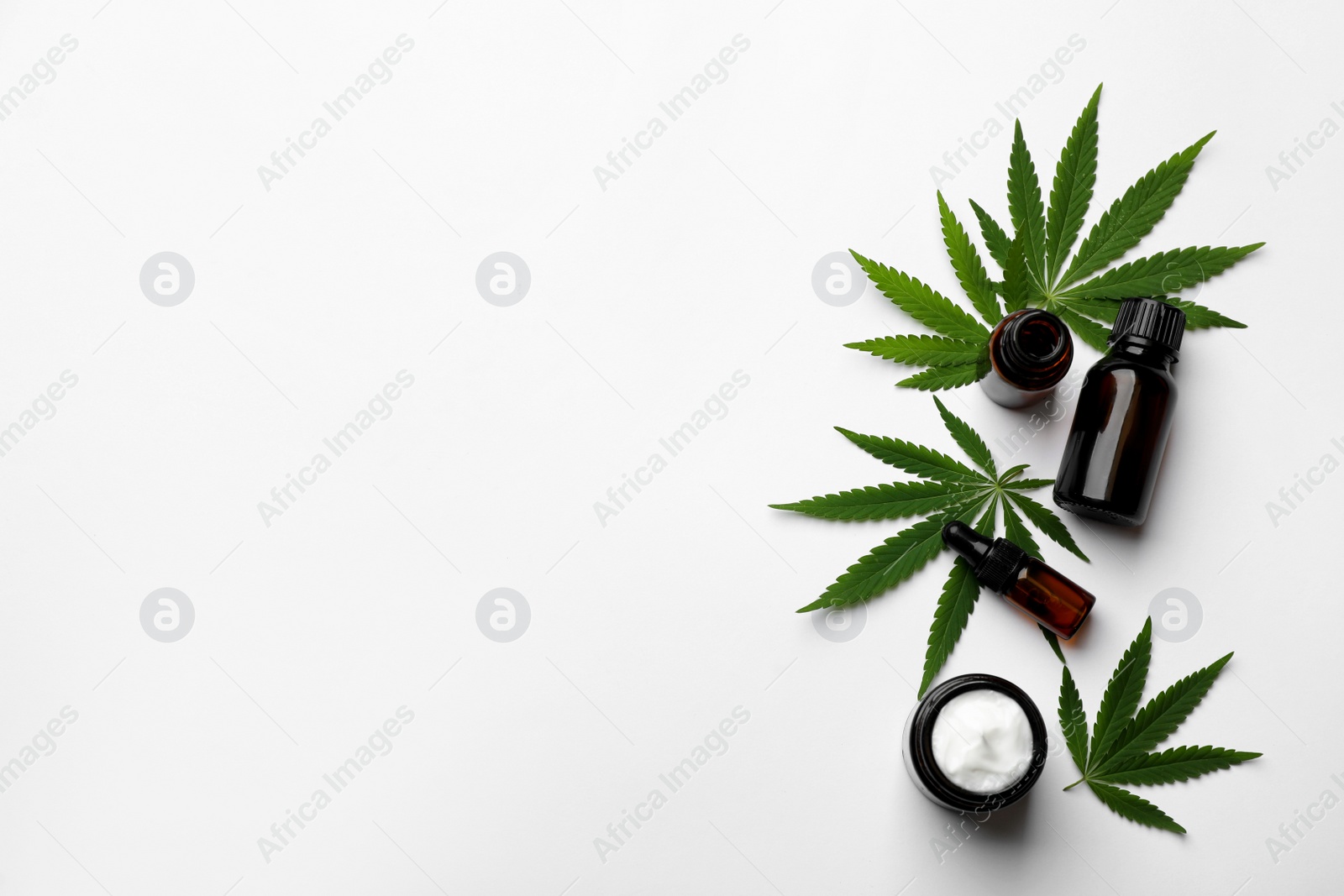 Photo of Flat lay composition with hemp leaves, CBD oil and THC tincture on white background, space for text