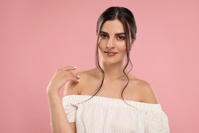 Photo of Beautiful woman with elegant jewelry on pink background