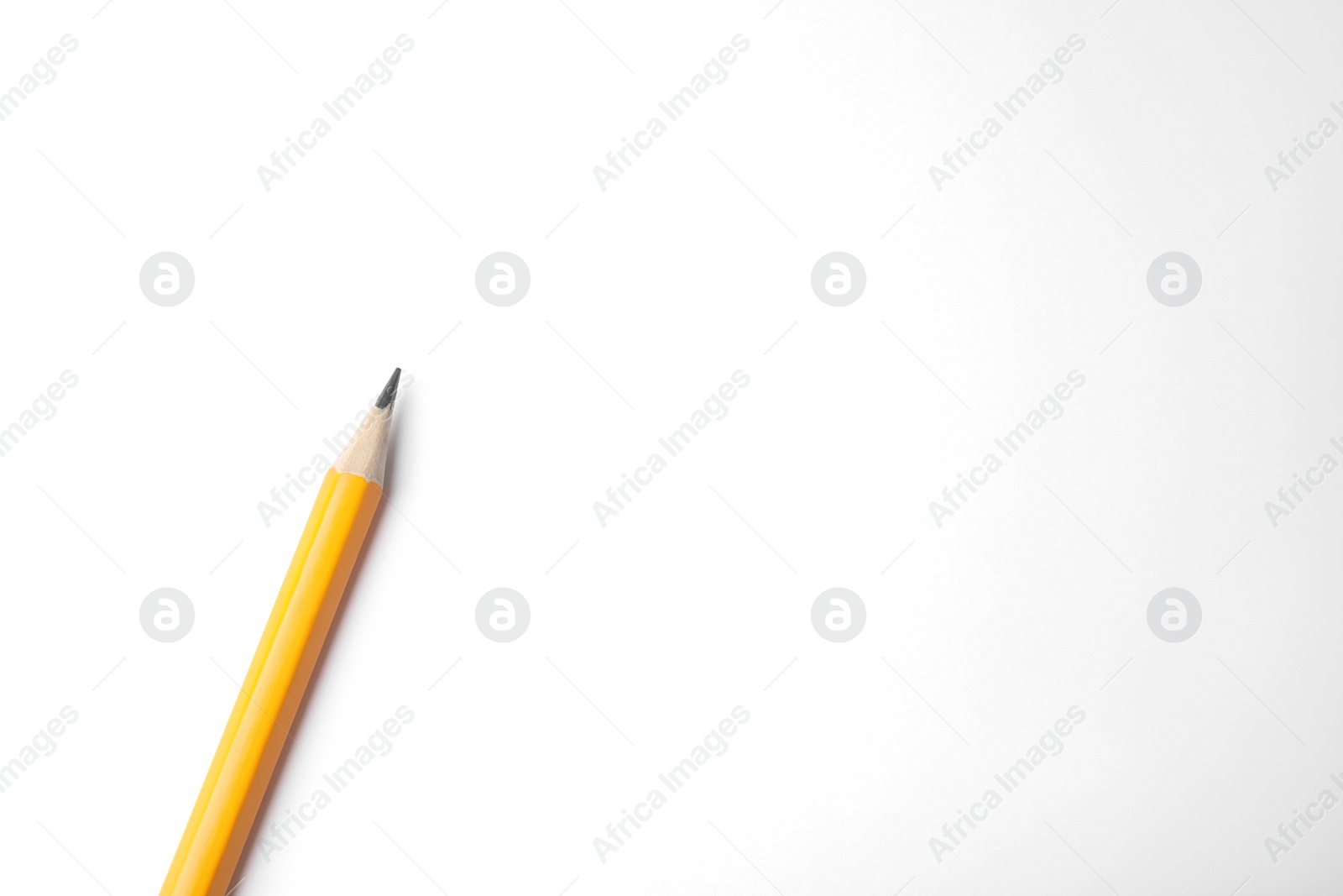 Photo of Graphite pencil on white background, top view. Space for text