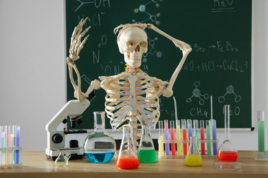 Photo of Skeleton and different chemistry glassware in classroom