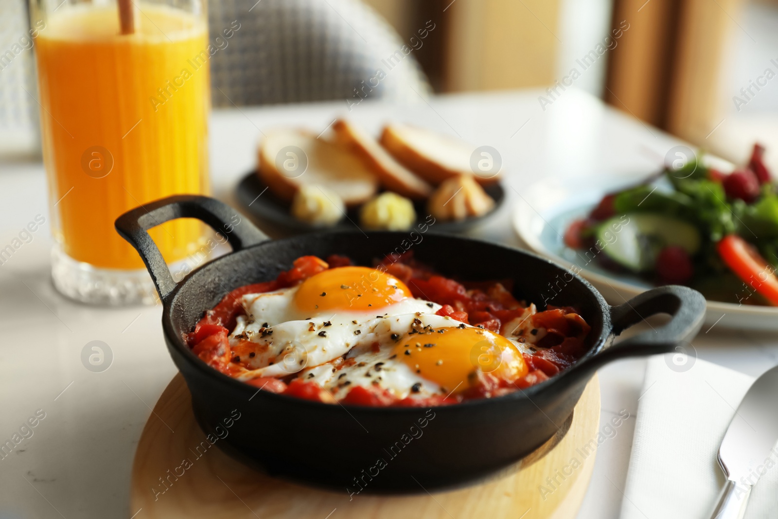 Photo of Tasty Shakshouka served on white table, closeup. Traditional Arabic dish