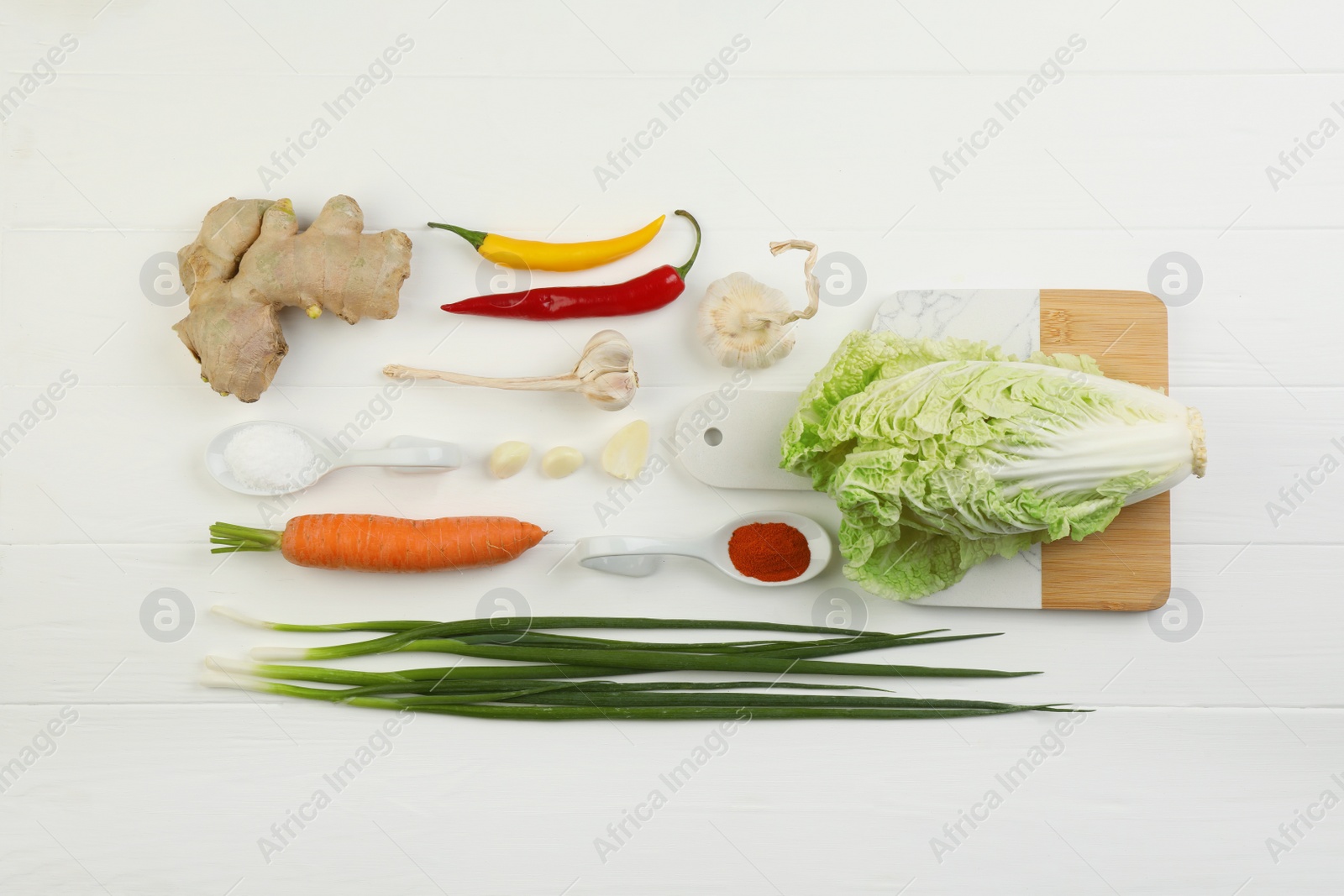 Photo of Flat lay composition with fresh Chinese cabbage and ingredients on white wooden table