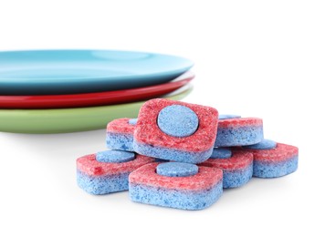 Photo of Many dishwasher detergent tablets on white background