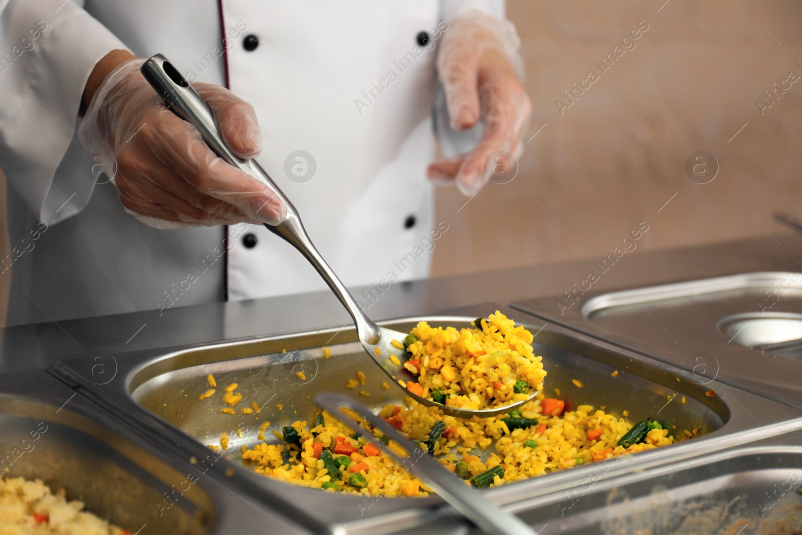 Photo of School canteen worker at serving line, closeup. Tasty food