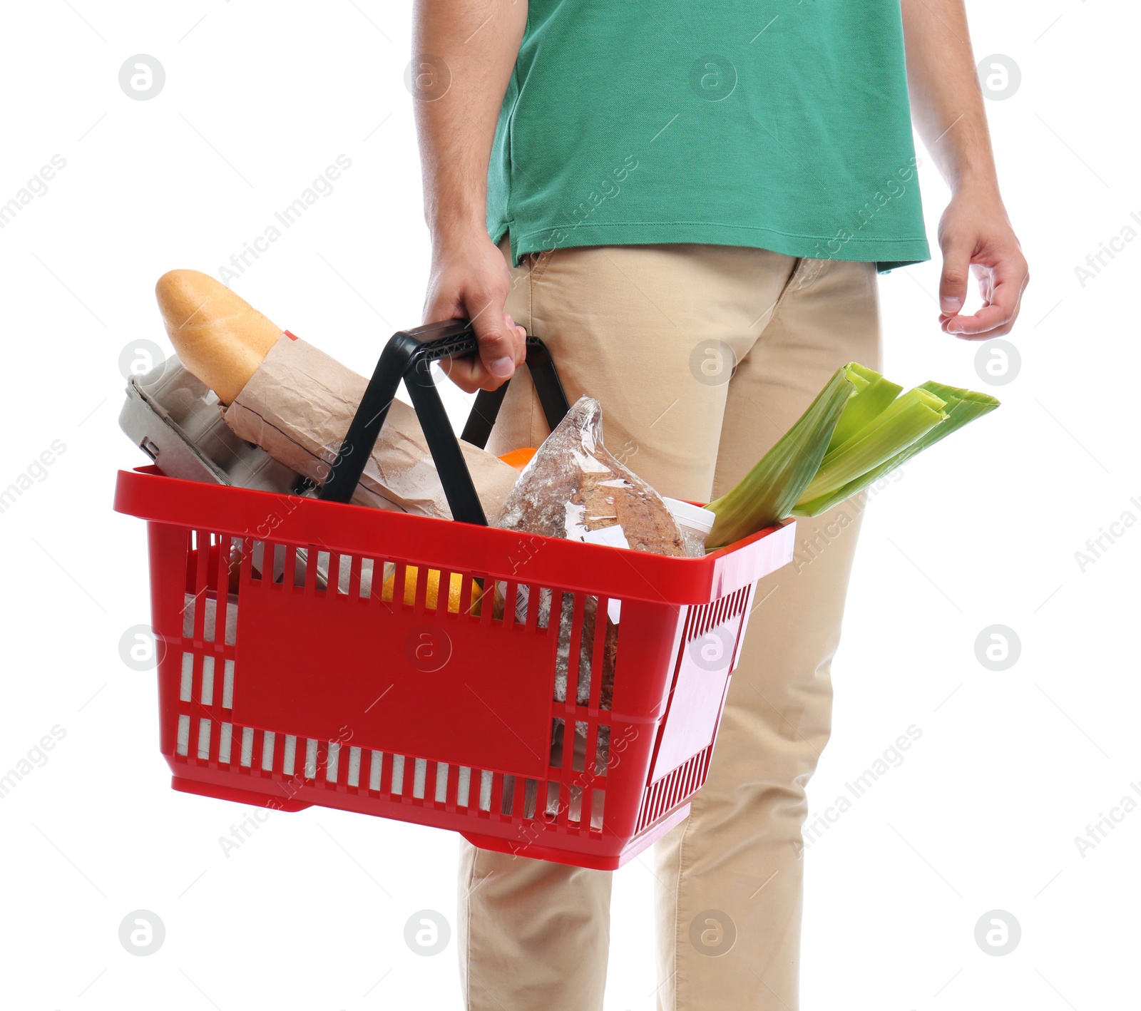 Photo of Young man with shopping basket full of products isolated on white, closeup