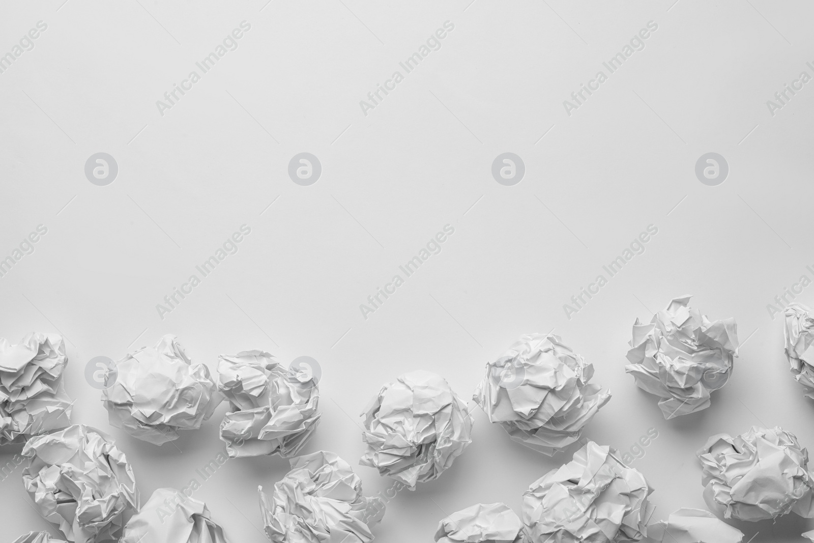 Photo of Crumpled sheets of paper on white background, top view