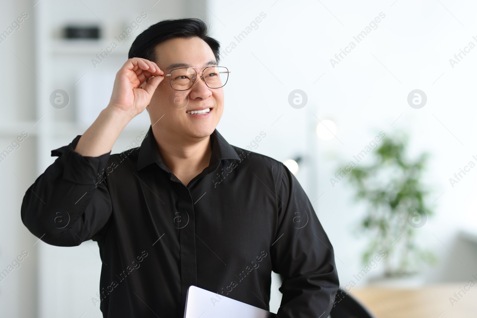 Photo of Portrait of smiling businessman in office. Space for text