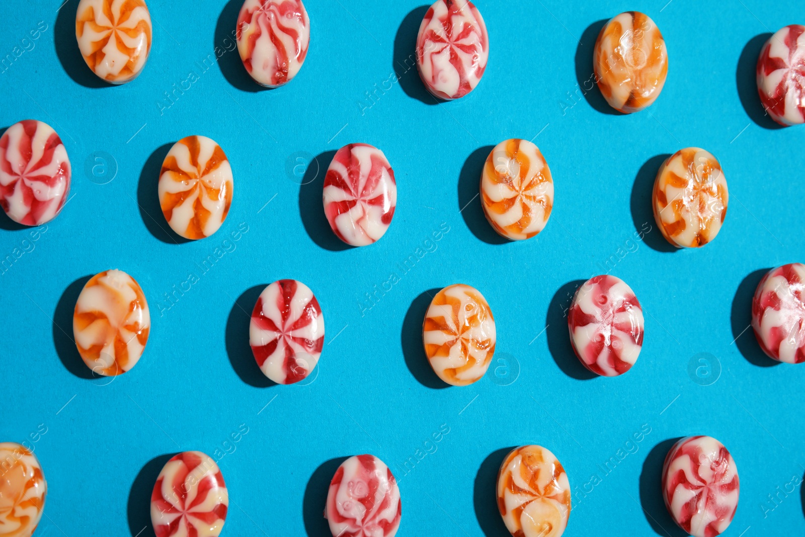 Photo of Flat lay composition with delicious colorful candies on color background