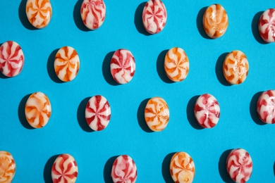 Photo of Flat lay composition with delicious colorful candies on color background