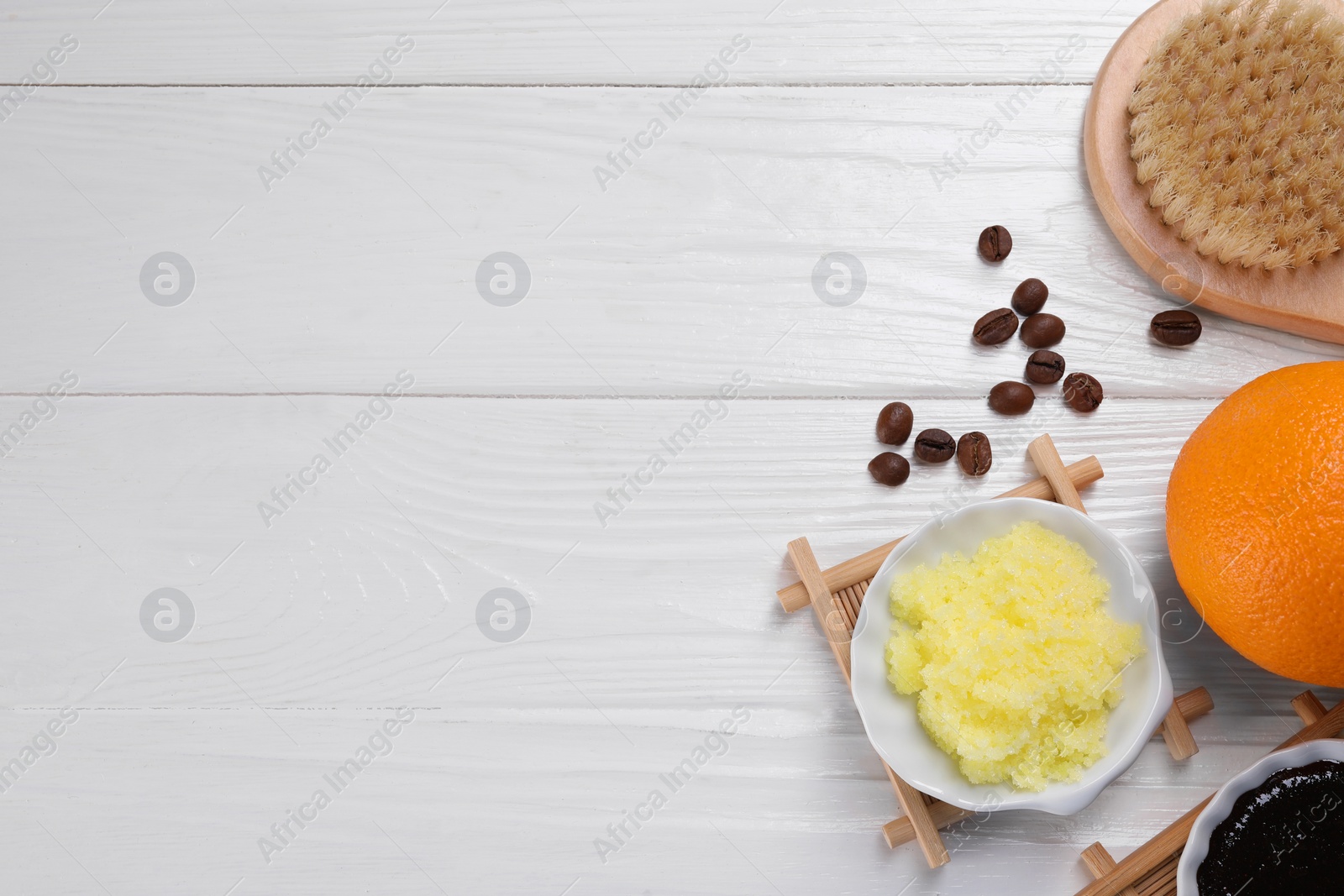 Photo of Flat lay composition with natural body scrub and fresh ingredients on white wooden table, space for text. Anti cellulite treatment