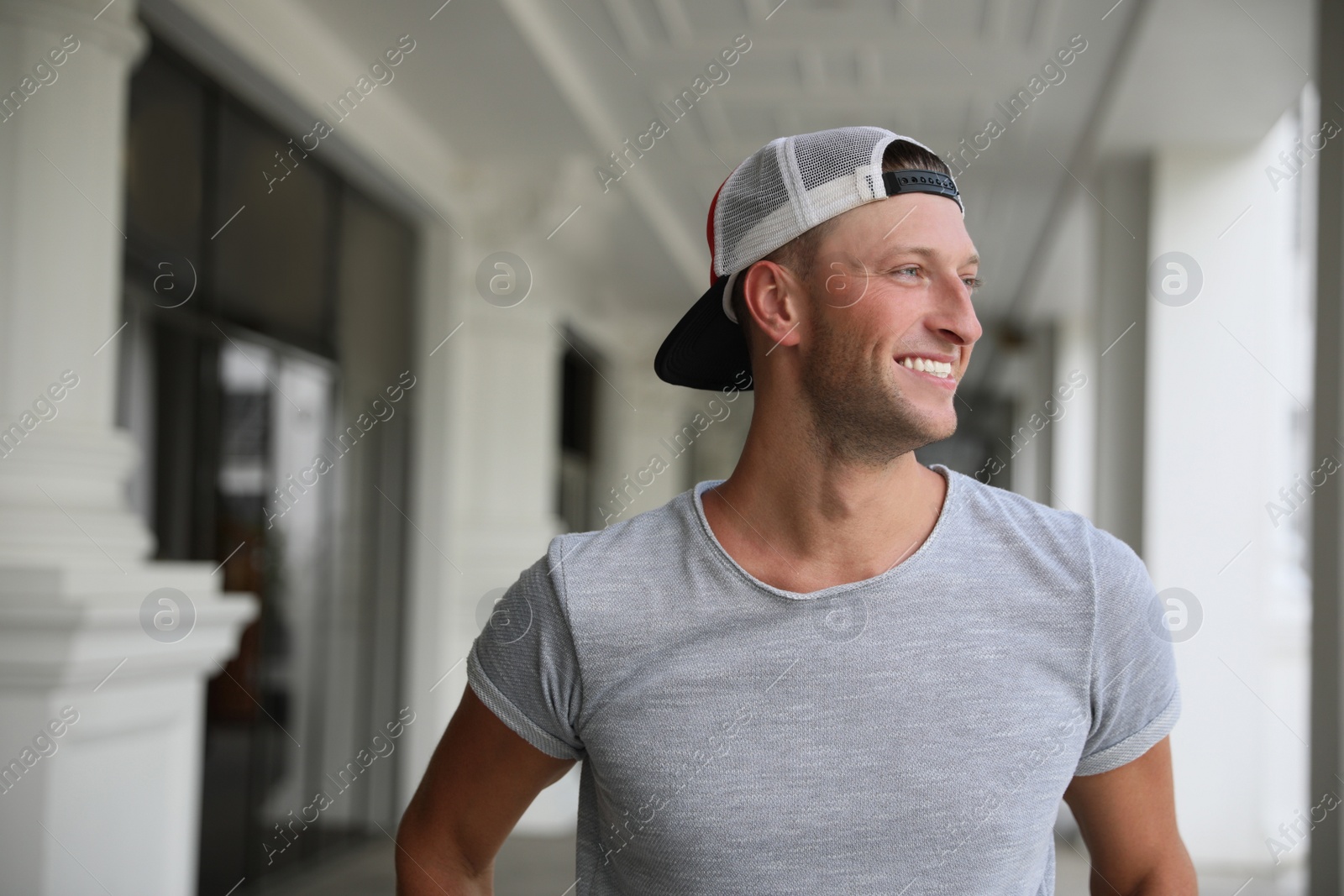 Photo of Handsome young man in stylish cap indoors