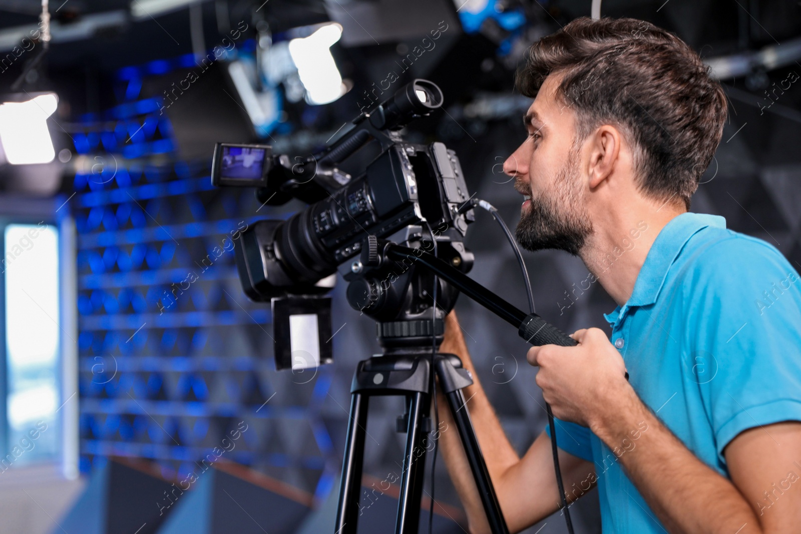 Photo of Professional video camera operator working in studio