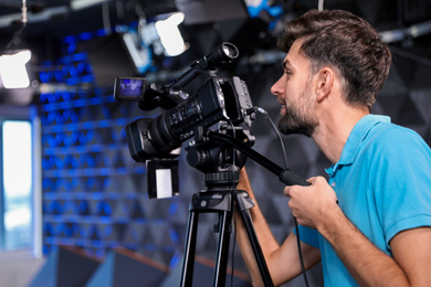 Photo of Professional video camera operator working in studio