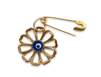 Photo of Evil eye safety pin on white background, top view