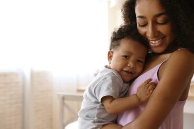 African-American woman with her baby at home. Happiness of motherhood