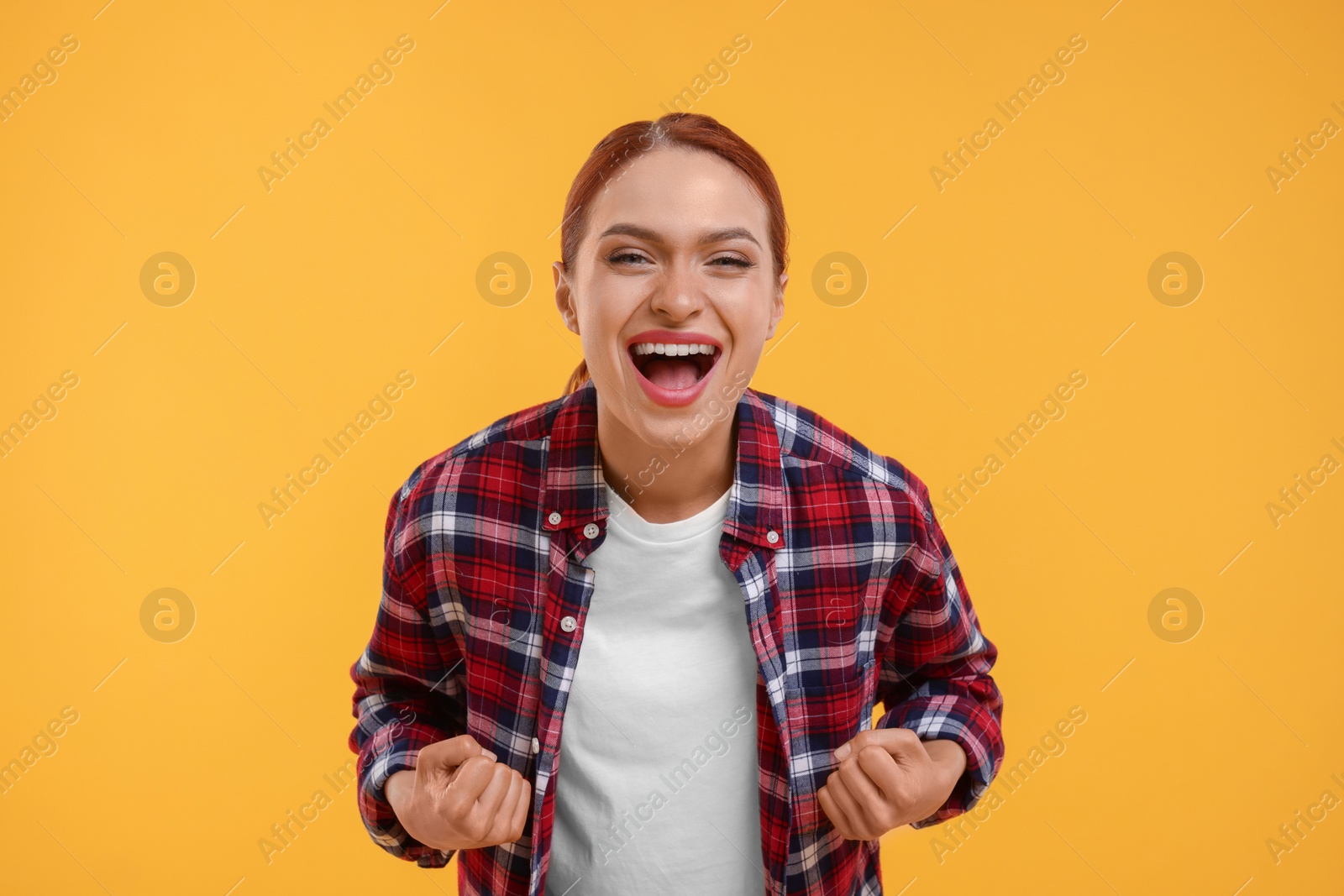 Photo of Happy sports fan celebrating on yellow background