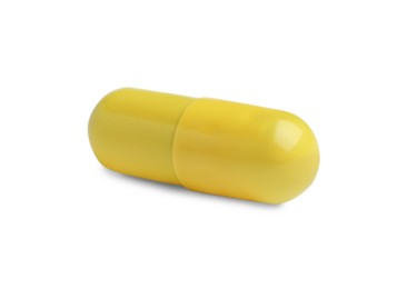 Photo of One yellow pill isolated on white. Medicinal treatment