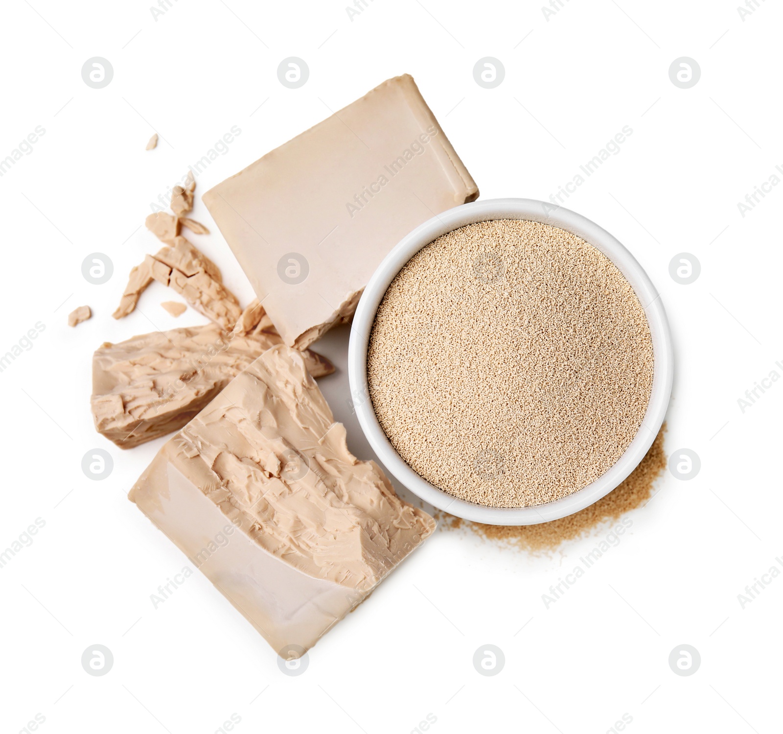 Photo of Compressed and granulated yeast on white background, top view